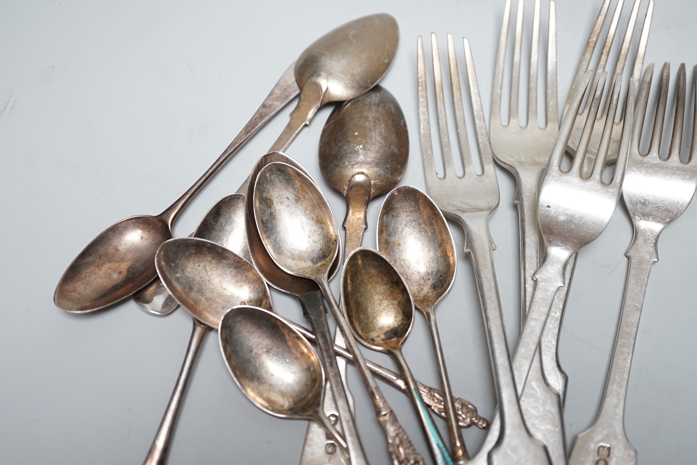 A small quantity of George III and later silver fiddle pattern and other cutlery, various dates and makers, 20.6oz.